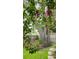 A blossoming tree graces a backyard with a weathered fence, showcasing natural beauty and tranquil outdoor living at 2912 Pinecrest Way, Sarasota, FL 34239