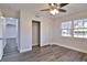 Comfortable bedroom with closet, modern ceiling fan, and two large windows at 2912 Pinecrest Way, Sarasota, FL 34239
