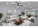Bright living room with neutral decor, featuring a ceiling fan and an elegant rug over modern flooring at 2912 Pinecrest Way, Sarasota, FL 34239
