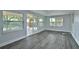 Bright living room featuring floor-to-ceiling windows and a sliding door, bringing the outdoors inside at 2912 Pinecrest Way, Sarasota, FL 34239