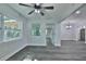 Inviting living room with modern flooring, a ceiling fan, and arched doorway, bathed in natural light at 2912 Pinecrest Way, Sarasota, FL 34239