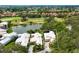 Wonderful home with a white roof, a private driveway, and beautiful landscaping on a golf course and pond at 7620 Club Ln, Sarasota, FL 34238