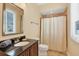 Cozy bathroom with dark wood vanity, neutral walls, and a shower with tile surround for a modern and clean feel at 7620 Club Ln, Sarasota, FL 34238