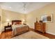 Inviting bedroom with a queen-sized bed, hardwood floors, and warm lighting creating a comfortable and relaxing atmosphere at 7620 Club Ln, Sarasota, FL 34238