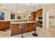 Gourmet kitchen featuring granite countertops, a kitchen island with seating, and stainless steel appliances at 7620 Club Ln, Sarasota, FL 34238