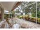 Enjoy the outdoors on this screened lanai with outdoor seating and views of the pond at 7620 Club Ln, Sarasota, FL 34238