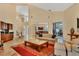 Open living room with high ceilings, wet bar, staircase to the second floor, and view of the dining room at 7620 Club Ln, Sarasota, FL 34238