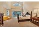 Spacious main bedroom with high ceilings, large windows, a private balcony and elegant furnishings for a luxurious retreat at 7620 Club Ln, Sarasota, FL 34238