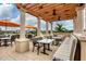 Outdoor seating area with tables, chairs, umbrellas, and scenic views of the surrounding area at 7620 Club Ln, Sarasota, FL 34238
