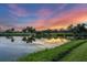 Scenic view of the pond and sunset from the property, with colorful sky and tranquil water at 7620 Club Ln, Sarasota, FL 34238