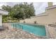 Community pool with brick surround, clear water, and lounge chairs for relaxing in a private setting at 7620 Club Ln, Sarasota, FL 34238