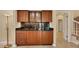 This wet bar features dark countertops and cabinets, a sink, and cabinet storage at 7620 Club Ln, Sarasota, FL 34238