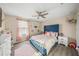 Bright bedroom with a full bed, window, and hardwood floors at 19369 Nearpoint Dr, Venice, FL 34292