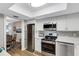 Modern kitchen featuring stainless steel appliances and white cabinetry at 3118 Lake Bayshore Dr # O216, Bradenton, FL 34205