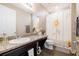 Bathroom with single vanity, shower/tub combo, and sunflower decor at 8798 Tuscany Isles Dr, Punta Gorda, FL 33950