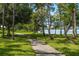 Paved lakeside walking path with lush green landscaping at 8798 Tuscany Isles Dr, Punta Gorda, FL 33950
