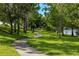 Paved lakeside walking path with lush green landscaping at 8798 Tuscany Isles Dr, Punta Gorda, FL 33950