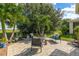 Relaxing backyard patio with seating area and lush landscaping at 8798 Tuscany Isles Dr, Punta Gorda, FL 33950