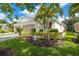 Beautiful home exterior with lush landscaping and double garage at 8798 Tuscany Isles Dr, Punta Gorda, FL 33950