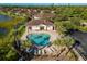 Community pool with a clubhouse and lake view at 8798 Tuscany Isles Dr, Punta Gorda, FL 33950