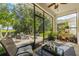 Cozy screened porch overlooking the patio and backyard at 8798 Tuscany Isles Dr, Punta Gorda, FL 33950