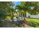 Landscaped backyard with patio and tropical plants at 8798 Tuscany Isles Dr, Punta Gorda, FL 33950