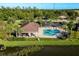 Community pool with a clubhouse and lake view at 8798 Tuscany Isles Dr, Punta Gorda, FL 33950