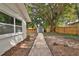 Stone pathway and wooden fence in side yard at 2912 Pinecrest Way, Sarasota, FL 34239