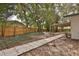 Landscaped backyard with stone pathway and shed at 2912 Pinecrest Way, Sarasota, FL 34239