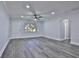 Bright living room with gray vinyl flooring, ceiling fan, and recessed lighting at 2912 Pinecrest Way, Sarasota, FL 34239