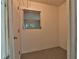 Small laundry room with window and concrete floor at 2912 Pinecrest Way, Sarasota, FL 34239