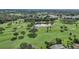 High-angle view of a golf course with a pond and mature trees at 6106 45Th W St, Bradenton, FL 34210