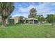 Front view of a single story home, featuring a large lawn at 6106 45Th W St, Bradenton, FL 34210