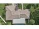 Top-down view of a house with a large roof and screened enclosure at 6106 45Th W St, Bradenton, FL 34210