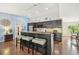 Kitchen island with seating for three, granite countertop and blue accent wall at 6106 45Th W St, Bradenton, FL 34210