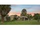 Single story home with a landscaped yard at sunset at 6106 45Th W St, Bradenton, FL 34210
