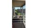 Screened balcony with outdoor seating and view of courtyard at 400 Base E Ave # 229, Venice, FL 34285