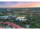 Breathtaking aerial view of community at sunset, showcasing homes and golf course at 7620 Club Ln, Sarasota, FL 34238