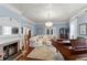 Elegant living room boasts a fireplace, piano, and detailed ceiling, creating a comfortable, cozy space at 1332 3Rd W Ave, Bradenton, FL 34205