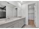 Bright bathroom features double vanity with quartz countertops and modern fixtures with access to walk-in closet and tile shower at 18773 Dayspring Pl, Venice, FL 34293