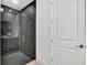 Stylish bathroom featuring a modern shower with unique tile design and glass door at 18773 Dayspring Pl, Venice, FL 34293