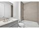 Modern bathroom features a sleek vanity, tiled shower/tub combo, and contemporary fixtures at 18773 Dayspring Pl, Venice, FL 34293