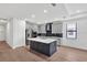 Updated kitchen boasts stainless appliances, custom cabinets, hardwood floors and a large center island at 18773 Dayspring Pl, Venice, FL 34293