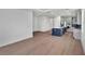 Open floor plan with hardwood floors seamlessly connects the living space with the modern kitchen at 18773 Dayspring Pl, Venice, FL 34293