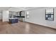 Open floor plan with hardwood floors seamlessly connects the living space with the modern kitchen at 18773 Dayspring Pl, Venice, FL 34293