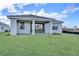 Spacious backyard with covered patio and grassy lawn at 18876 Daybreak Dr, Venice, FL 34293