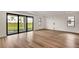 Spacious living room with hardwood floors and sliding glass doors at 18876 Daybreak Dr, Venice, FL 34293