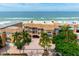 Aerial view of beachfront property with ocean and palm trees at 1900 Gulf N Dr # 1, Bradenton Beach, FL 34217