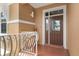 Building entry with brown door and white railing at 1900 Gulf N Dr # 1, Bradenton Beach, FL 34217
