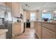 Open kitchen with custom cabinets, stainless steel appliances and breakfast bar seating at 1900 Gulf N Dr # 1, Bradenton Beach, FL 34217